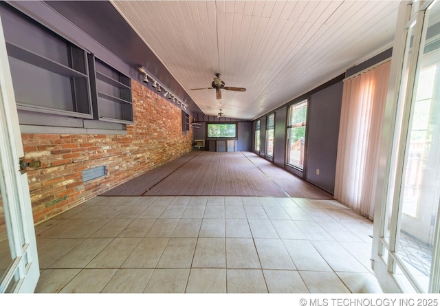 unfurnished sunroom with ceiling fan and wood ceiling