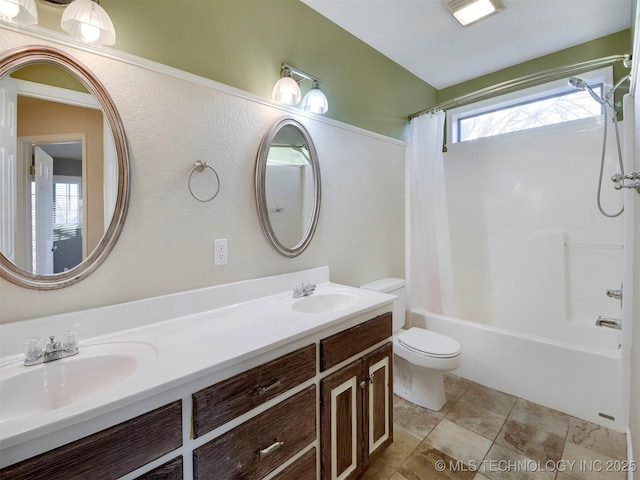 full bathroom with vanity, shower / bath combination with curtain, and toilet