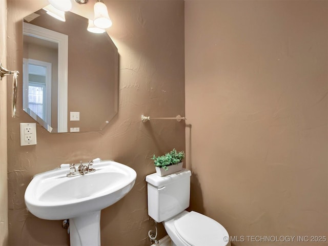 bathroom with toilet and sink