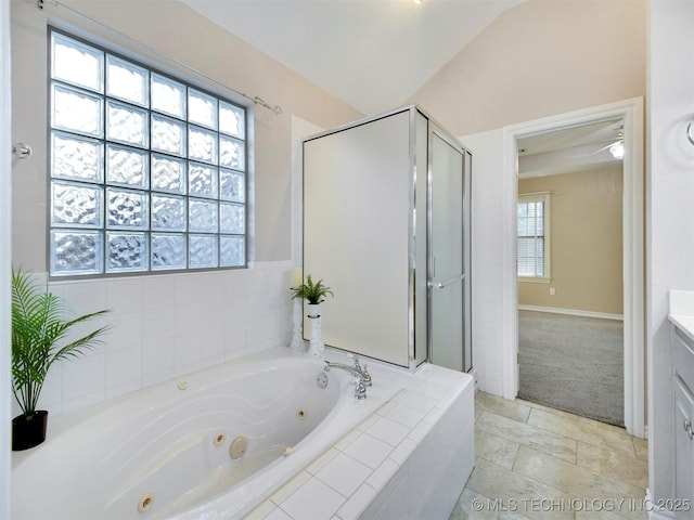 bathroom with independent shower and bath, a wealth of natural light, and vaulted ceiling