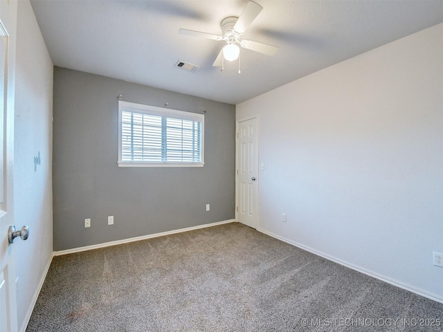 carpeted spare room with ceiling fan