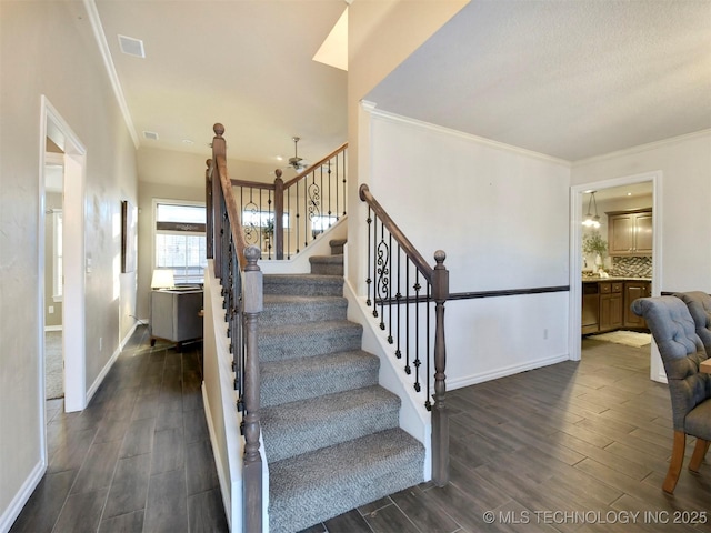 stairway featuring crown molding