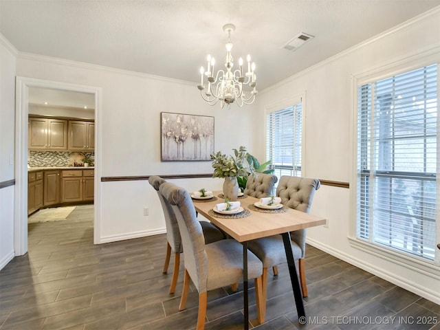 dining space featuring ornamental molding and a notable chandelier