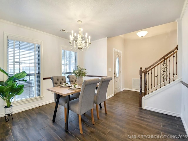 dining room featuring a chandelier and ornamental molding