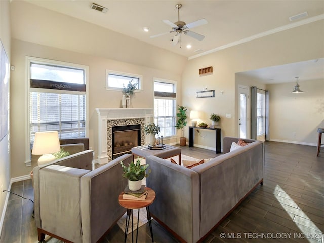 living room featuring a tile fireplace, a wealth of natural light, ceiling fan, and lofted ceiling