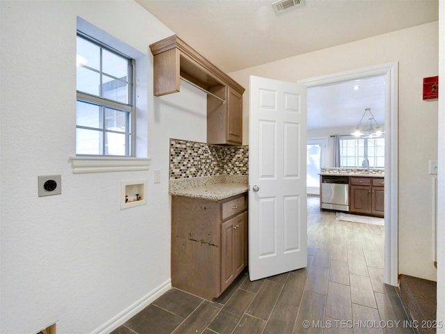 washroom with electric dryer hookup, cabinets, hookup for a washing machine, and a chandelier