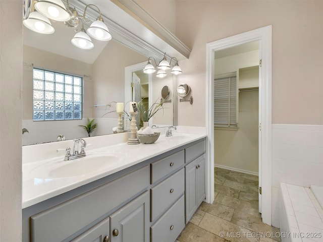 bathroom with vanity and lofted ceiling