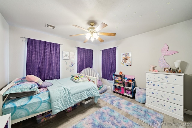 bedroom with ceiling fan and light hardwood / wood-style flooring