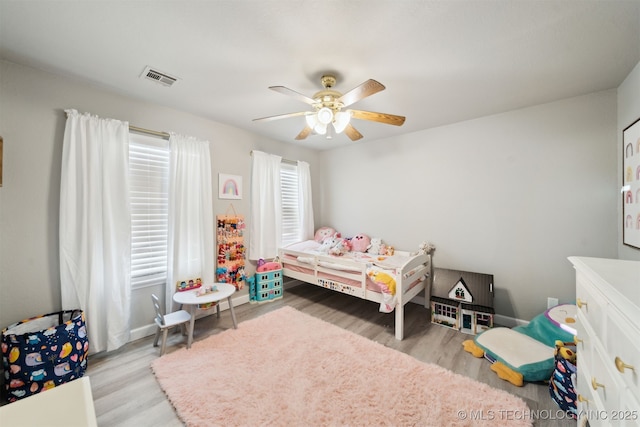 bedroom with ceiling fan and light hardwood / wood-style floors