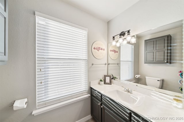 bathroom featuring vanity and toilet