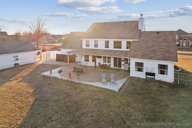 back of house featuring a yard and a patio