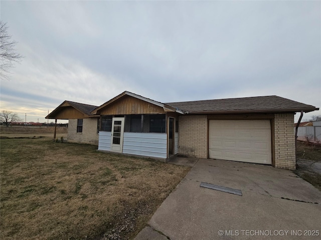 single story home featuring a garage and a front lawn