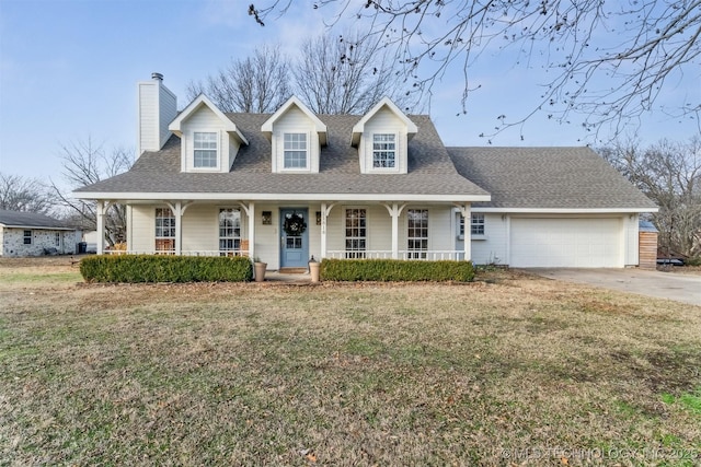 new england style home with covered porch, a garage, and a front yard