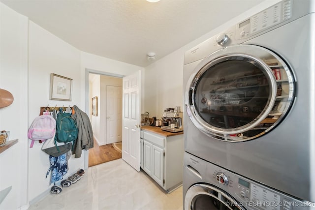 washroom with stacked washer and clothes dryer