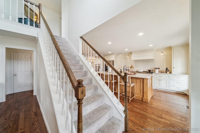 stairway featuring wood-type flooring