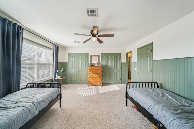 11818 N Harvard Ave, Skiatook, OK 74070 - bedroom with two closets, carpet flooring, and a ceiling fan