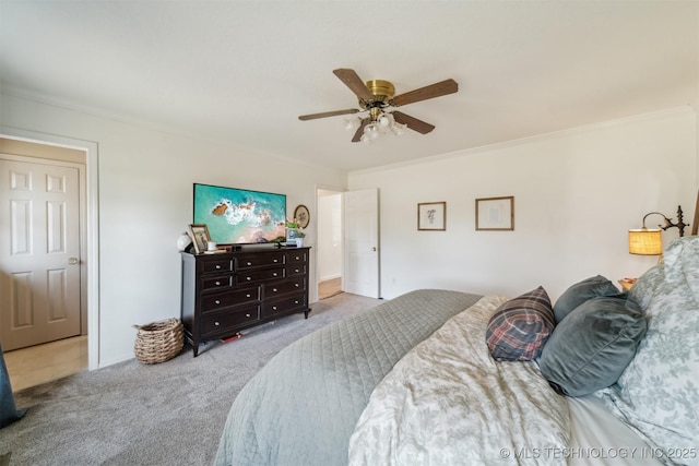 bedroom with ceiling fan, ornamental molding, and light carpet