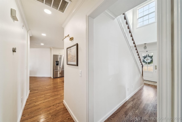 11818 N Harvard Ave, Skiatook, OK 74070 - hallway with stairs, wood finished floors, crown molding, baseboards, and recessed lighting