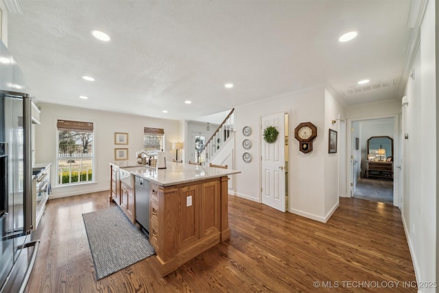 kitchen featuring a center island with sink, dishwasher, crown molding, and dark wood-type flooring