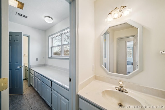 bathroom featuring plenty of natural light, vanity, and tile patterned flooring