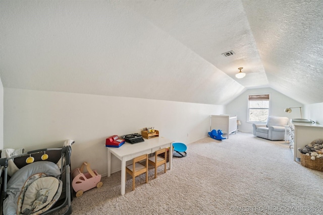 playroom with carpet flooring, a textured ceiling, and lofted ceiling