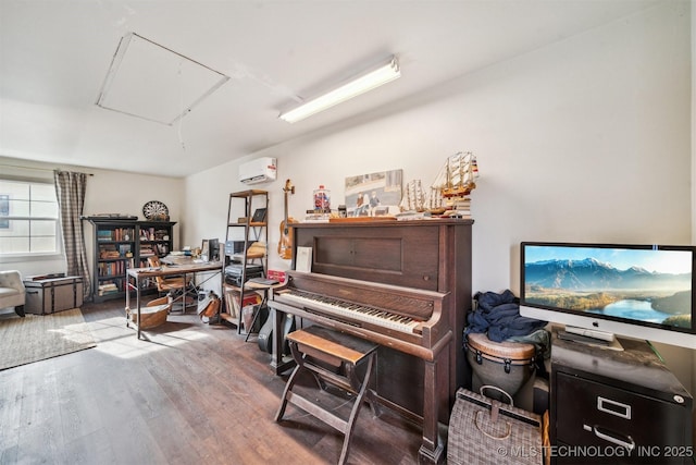 misc room featuring a wall unit AC and hardwood / wood-style floors