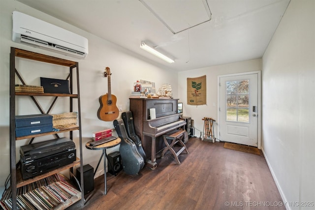 misc room with dark hardwood / wood-style floors and a wall mounted air conditioner