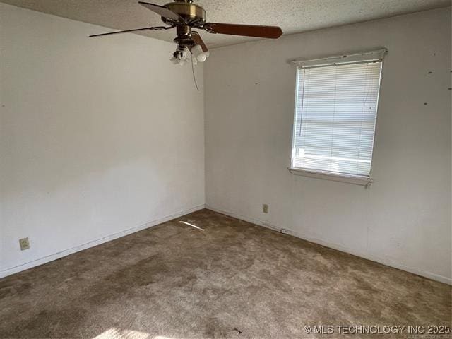 carpeted empty room with ceiling fan and a textured ceiling