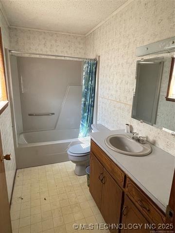 full bathroom with vanity, shower / bathtub combination with curtain, a textured ceiling, and toilet