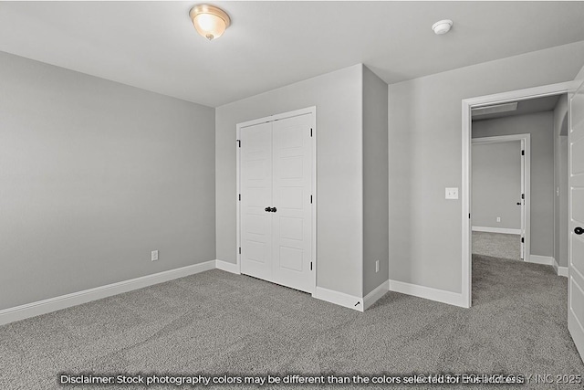 unfurnished bedroom with carpet, baseboards, and a closet