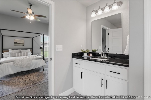 bathroom featuring connected bathroom, vanity, baseboards, and ceiling fan