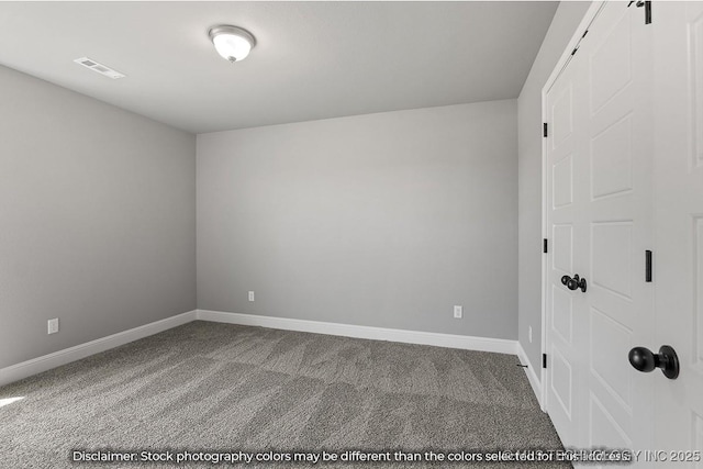 carpeted spare room featuring baseboards and visible vents