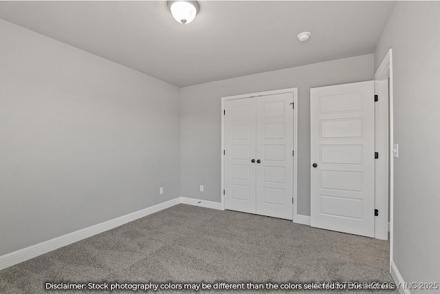 unfurnished bedroom featuring a closet, carpet flooring, and baseboards