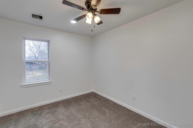 carpeted spare room with ceiling fan