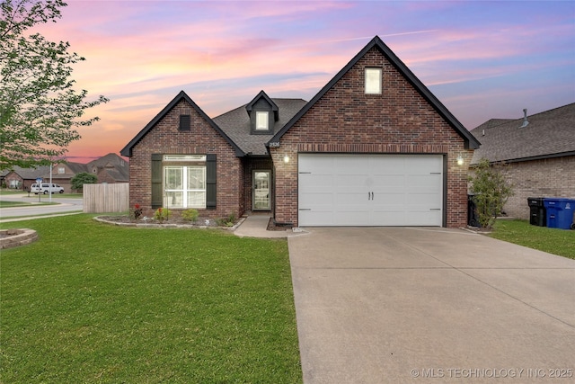 view of front facade featuring a garage and a lawn