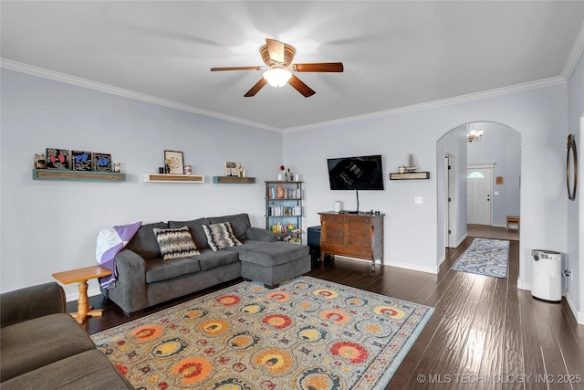 living room with dark hardwood / wood-style flooring, ceiling fan, and ornamental molding