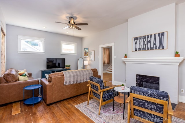 living room featuring ceiling fan and wood-type flooring