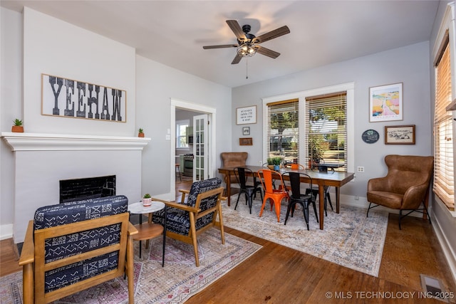 dining room with hardwood / wood-style flooring and ceiling fan