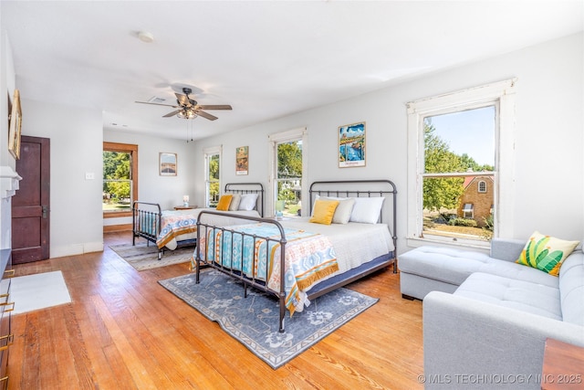 bedroom with hardwood / wood-style floors and ceiling fan