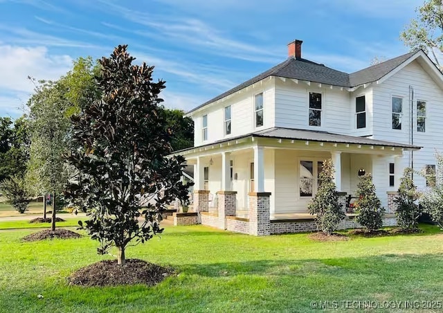 exterior space featuring a porch and a front lawn