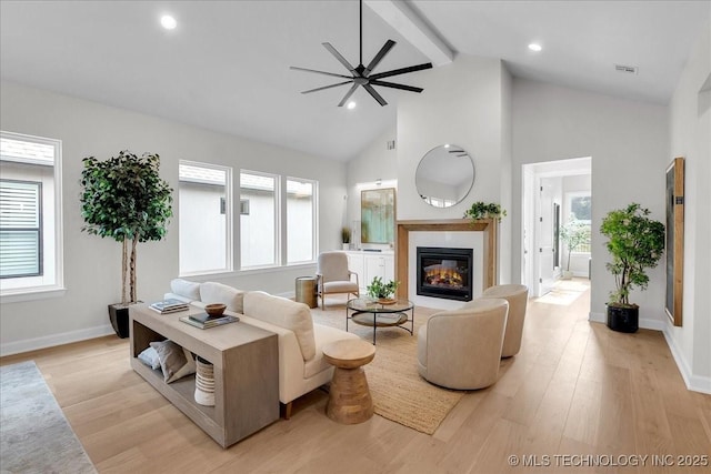 living room with ceiling fan, high vaulted ceiling, beam ceiling, and light hardwood / wood-style flooring