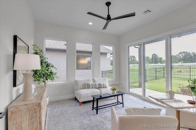 interior space with a wealth of natural light and ceiling fan