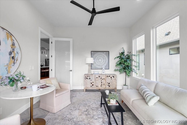 living room with a healthy amount of sunlight, hardwood / wood-style flooring, and ceiling fan