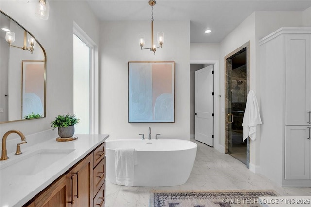 bathroom featuring plus walk in shower, vanity, and a chandelier