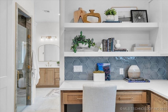 interior space featuring vanity and backsplash