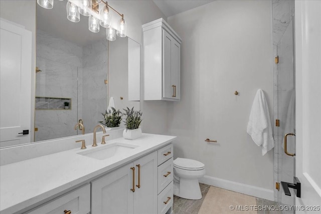 bathroom featuring vanity, a shower with door, and toilet