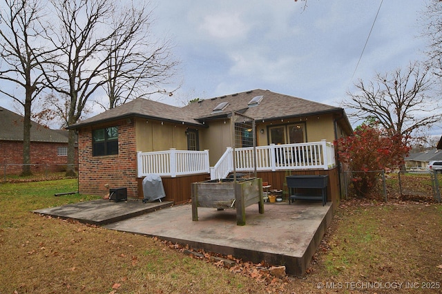 back of house with a patio and a hot tub