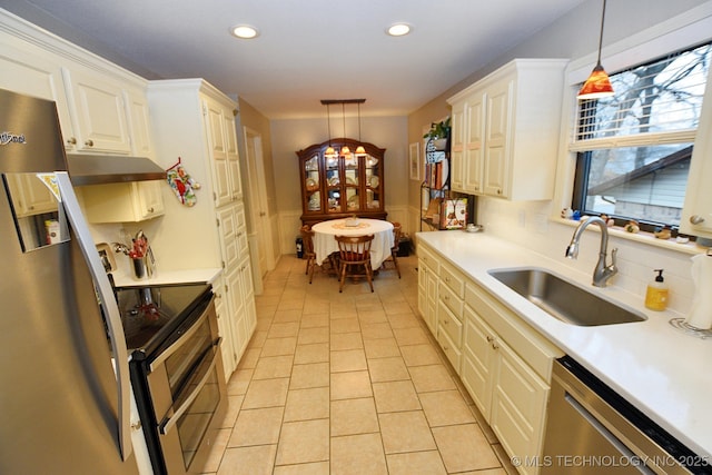 kitchen featuring pendant lighting, light tile patterned floors, stainless steel appliances, and sink