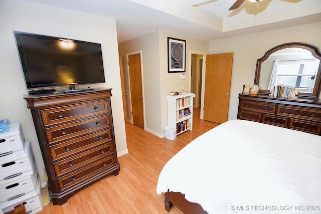 bedroom with light hardwood / wood-style floors and ceiling fan