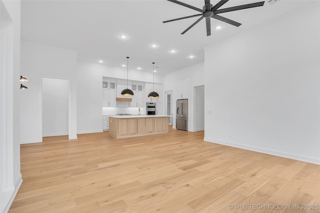 unfurnished living room with ceiling fan, sink, light hardwood / wood-style flooring, and crown molding